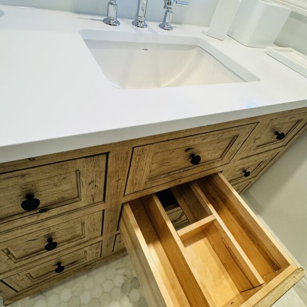 A bathroom vanity, with one drawer pulled open.